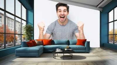 Portrait of smiling man with the fists up isolated a white background Wall mural